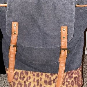 Jean drawstring flap backpack with cheetah print on bottom